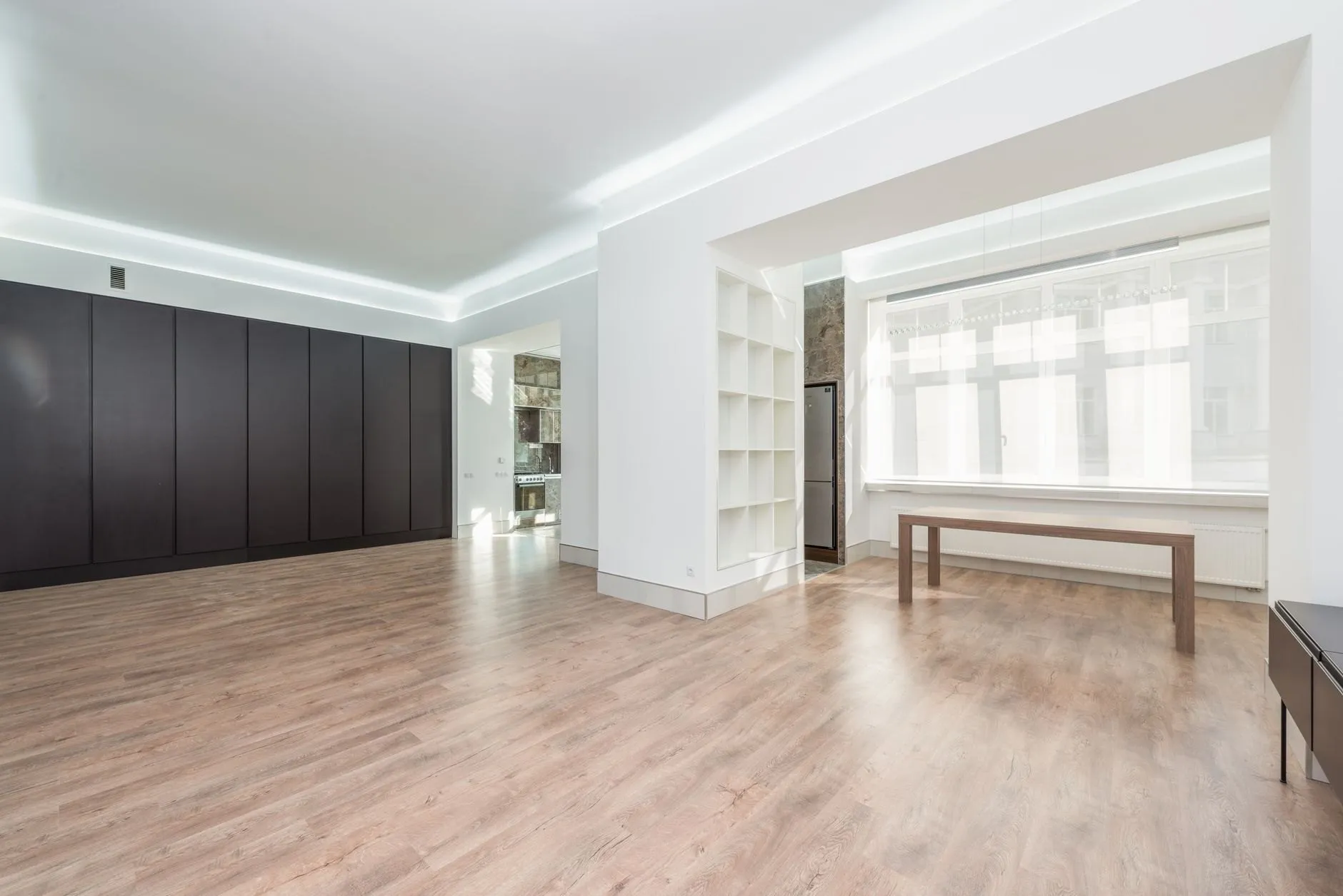 Open living room with oak floor and full-height windows